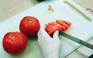 Photo by Chloe Lewis Copyright UBC chopping tomatoes
